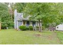 Charming blue home with a well-manicured lawn and mature trees at 859 Sangria Ct, Lawrenceville, GA 30043