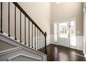 Bright foyer featuring hardwood floors, staircase with iron spindles, wainscotting, and natural light at 1021 Reddy Farm Rd, Grayson, GA 30017