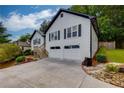 Charming home featuring a two-car garage, front yard landscaping and a welcoming entrance at 2111 Yorkshire Ct, Woodstock, GA 30189