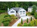 Charming home featuring a two-car garage, front yard landscaping and a welcoming entrance at 2111 Yorkshire Ct, Woodstock, GA 30189