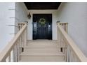 Inviting entryway with a decorative front door and wooden steps leading up to the entrance at 2111 Yorkshire Ct, Woodstock, GA 30189