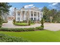 Expansive estate showcasing manicured lawns, lush landscaping, and a circular driveway leading to the main house and garage at 3977 Sweet Bottom Dr, Duluth, GA 30096