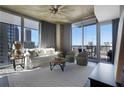 Cozy living room with large windows, comfortable seating, and sleek decor offers a relaxing space with city views at 855 Peachtree Ne St # 1703, Atlanta, GA 30308
