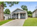 Charming single-story home with a covered porch, a well-manicured lawn, and a private driveway at 1062 Grant Terrace, Atlanta, GA 30315