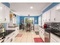 Eat in kitchen featuring white cabinets, granite countertops, and tile backsplash at 4259 Kings Troop Rd, Stone Mountain, GA 30083