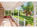 Inviting front porch with a porch swing and brick flooring at 4259 Kings Troop Rd, Stone Mountain, GA 30083