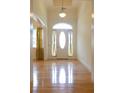 Elegant foyer with hardwood floors, a front door with glass, and tall ceilings with natural light at 430 English Ivy Way, Woodstock, GA 30188