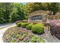Stone community entrance sign amidst landscaped flowerbeds and bushes, showing 'Brookmere West' at 795 Creek Glen Rd, Mableton, GA 30126