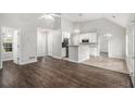 Open-concept floor plan featuring wood floors, vaulted ceilings, and a bright entryway in neutral colors at 104 Terrapin Ct, Carrollton, GA 30116