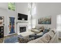 Bright living room with high ceilings, fireplace, large windows and elegant decor at 2061 Pinnacle Pointe Dr, Norcross, GA 30071