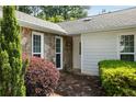 Close up of the entrance with stone exterior, clean white door, and mature landscaping elements at 3519 Oak Knoll Dr, Marietta, GA 30068
