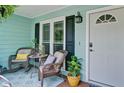 Cozy front porch featuring comfortable seating, plants, and a welcoming entrance, perfect for relaxation at 368 Lambeth Dr, Hiram, GA 30141