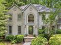 Close up of a home's facade with gray stucco, black trim, and arched windows at 4402 Windsor Oaks Chase, Marietta, GA 30066