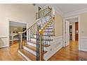 Classic staircase featuring wood steps, wrought iron railings, and elegant trim at 4402 Windsor Oaks Chase, Marietta, GA 30066