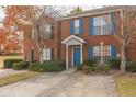 Inviting brick townhome with blue shutters, a well-maintained lawn, and a convenient concrete driveway at 3151 Kingswood Gln, Decatur, GA 30034