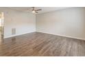 Bright, open living room with wood-look floors, a ceiling fan, and neutral paint, offering a blank canvas at 3151 Kingswood Gln, Decatur, GA 30034