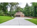 Long driveway leading to a two-car garage and a well-maintained yard at 4366 Cedar Wood Sw Dr, Lilburn, GA 30047