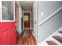 Entryway featuring hardwood floors, stairs, and a glimpse of the kitchen at 456 Harmony Grove Rd, Lilburn, GA 30047
