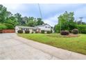 Well-maintained home with mature trees, manicured landscaping, and a long driveway at 456 Harmony Grove Rd, Lilburn, GA 30047