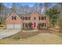 Charming brick two-story house with a two-car garage, black shutters, and a manicured front lawn at 465 Woodbrook Ways, Lawrenceville, GA 30043