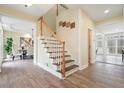 Welcoming foyer with hardwood floors, a staircase with white risers, and views of adjacent rooms at 465 Woodbrook Ways, Lawrenceville, GA 30043