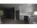 Modern kitchen features white cabinets, stainless steel sink and new flooring creating an inviting space at 81 Burbank Nw Dr, Atlanta, GA 30314