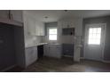 Bright kitchen features white cabinets, stainless steel sink and modern wood grain flooring at 81 Burbank Nw Dr, Atlanta, GA 30314