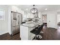 Modern kitchen with stainless steel appliances, a granite island, and dark hardwood flooring at 912 Ira Sw St, Atlanta, GA 30310