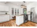 Bright kitchen features white cabinets, granite countertops, stainless steel appliances and wood floors at 1195 Cameron Ct, Atlanta, GA 30306