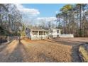 A charming home featuring a cozy front porch, and a well-maintained yard at 2248 Bethel Rd, Conyers, GA 30012