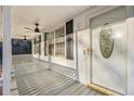 Inviting front porch features a ceiling fan, white railing and front door at 2248 Bethel Rd, Conyers, GA 30012