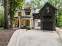 Beautiful stone house with a metal roof and an attached garage with an archway at 306 Pinecrest Ne Rd, Atlanta, GA 30342