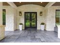 Stately front entrance with double doors, stone pillars, and dark gray tile at 306 Pinecrest Ne Rd, Atlanta, GA 30342