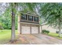 Charming two-story home features a brick facade and a convenient two-car garage at 3469 Stoneleigh Walk, Lithonia, GA 30038