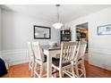 Bright dining room with views into the kitchen featuring an adjacent bar and hardwood floors at 4003 Maple Ridge Nw Ln, Acworth, GA 30101
