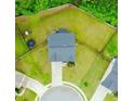 Aerial view of a private backyard with green lawn and mature trees at 735 Sweethaven Ln, Loganville, GA 30052