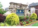 Stone sign for the Hollowstone community surrounded by colorful flowerbeds and greenery at 735 Sweethaven Ln, Loganville, GA 30052