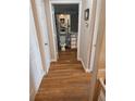Hallway with hardwood floors leading to a bathroom with a toilet and vanity at 1075 Peachtree Ne Walk # 506, Atlanta, GA 30309