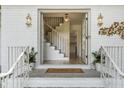 Inviting front entrance with double glass doors, elegant lighting fixtures, and stylish decor on a freshly painted white brick facade at 3981 Longview Dr, Chamblee, GA 30341