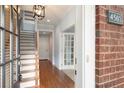 Bright foyer showcasing hardwood floors and an open staircase, leading to a welcoming living space at 4503 Kendall Way, Roswell, GA 30075