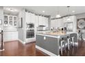 Bright, modern kitchen with white cabinets, stainless steel appliances and granite countertops at 5075 Havenbrooke Ct, Cumming, GA 30040