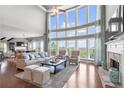 Spacious living room with a wall of windows, fireplace and hardwood floors at 5075 Havenbrooke Ct, Cumming, GA 30040