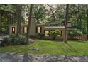 Charming single-story home with a well-maintained lawn and mature trees enhancing its curb appeal at 609 Redwood Drive Dr, Woodstock, GA 30189