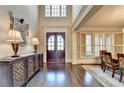 Elegant foyer with hardwood floors, dining room access, and double front door at 10125 Brixton Pl, Suwanee, GA 30024