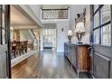 Grand foyer showcasing hardwood floors, staircase, and entry to dining room at 10125 Brixton Pl, Suwanee, GA 30024