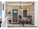 Inviting front porch with rocking chairs, flower pots, and a charming welcome sign at 242 Crestbrook Ln, Dallas, GA 30157