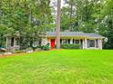 Traditional brick home with a well-maintained lawn, tasteful landscaping, and a vibrant red front door, offering great curb appeal at 773 N Superior Ave, Decatur, GA 30033