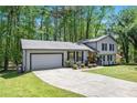 Inviting home featuring an attached garage and a freshly sealed driveway at 2022 Ramblewood Ne Ct, Marietta, GA 30062