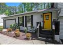 Close up of a bright yellow door with black trim and a 'welcome' wreath at 2022 Ramblewood Ne Ct, Marietta, GA 30062