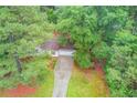 Aerial view of home with lush green surroundings, featuring a long driveway and a well-maintained lawn at 2088 Blackberry Ln, Auburn, GA 30011
